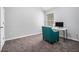Home office showcasing neutral paint, plush carpet, a bright window, and an accent chair with an included workspace at 6427 Grey Fox Way, Riverdale, GA 30296