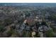 A panoramic view reveals a neighborhood nestled among mature trees, tennis court, and beautiful homes at 420 Argonne Nw Dr, Atlanta, GA 30305