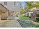 View of the backyard with an outdoor kitchen, brick walls, green grass, and stone pavers at 420 Argonne Nw Dr, Atlanta, GA 30305