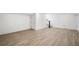 Spacious basement with light hardwood floors, white walls, and access to stairs and a door at 420 Argonne Nw Dr, Atlanta, GA 30305