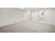 Basement with carpet floors, white walls, doors, and an open doorway to a bathroom at 420 Argonne Nw Dr, Atlanta, GA 30305