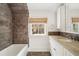 Charming bathroom featuring tub, shower, and granite countertop vanity and a window at 420 Argonne Nw Dr, Atlanta, GA 30305