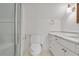 Bright bathroom featuring a glass shower, toilet, vanity with white countertop, and wall lighting at 420 Argonne Nw Dr, Atlanta, GA 30305