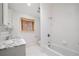 Bathroom featuring a marble countertop vanity, tub and shower combination and window at 420 Argonne Nw Dr, Atlanta, GA 30305