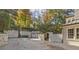 Large driveway with white brick walls leads to garage, offering ample parking and privacy at 420 Argonne Nw Dr, Atlanta, GA 30305
