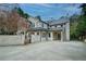 Rear exterior of the home features white brick, a black metal roof, and a large concrete patio at 420 Argonne Nw Dr, Atlanta, GA 30305