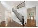 Elegant foyer with hardwood floors, paneled walls, and staircase with black railings at 420 Argonne Nw Dr, Atlanta, GA 30305