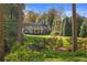 Stately home features a lush front yard with mature trees and manicured landscaping at 420 Argonne Nw Dr, Atlanta, GA 30305
