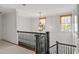 Upstairs hallway with wood-paneled walls, chandelier, and dark wood banister at 420 Argonne Nw Dr, Atlanta, GA 30305