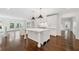 Bright kitchen with white cabinets, marble counters, island, pendant lighting and dark wood floors at 420 Argonne Nw Dr, Atlanta, GA 30305