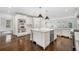 Open-concept white kitchen with stainless appliances, island and hardwood floors at 420 Argonne Nw Dr, Atlanta, GA 30305