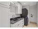 Laundry room featuring a stacked washer and dryer, sink, and white cabinets at 420 Argonne Nw Dr, Atlanta, GA 30305