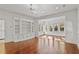 Bright living room boasts hardwood floors, built-in shelving and cabinetry, and view to sunroom at 420 Argonne Nw Dr, Atlanta, GA 30305