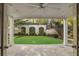 Covered patio overlooking a manicured backyard with brick wall, greenery, and stone staircase at 420 Argonne Nw Dr, Atlanta, GA 30305