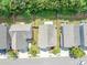 Aerial view of homes with well-manicured lawns, driveways, and mature trees at 363 Lobdale Falls Dr, Lawrenceville, GA 30045