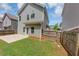 Backyard with green lawn and wooden fence, offering privacy and space to enjoy the outdoors at 363 Lobdale Falls Dr, Lawrenceville, GA 30045
