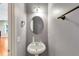 A half bath with a pedestal sink and wood trim at 363 Lobdale Falls Dr, Lawrenceville, GA 30045
