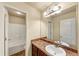 Bathroom featuring double sinks, a large mirror, and a separate door leading to the toilet and tub area at 363 Lobdale Falls Dr, Lawrenceville, GA 30045