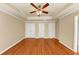 An empty bedroom space showcasing three closets and hardwood floors at 363 Lobdale Falls Dr, Lawrenceville, GA 30045