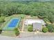 Aerial view of community pool, tennis courts, and clubhouse surrounded by lush greenery at 363 Lobdale Falls Dr, Lawrenceville, GA 30045