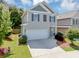 Charming two-story home features a two-car garage, neutral siding and dark shutters at 363 Lobdale Falls Dr, Lawrenceville, GA 30045