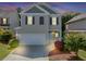 Charming two-story home features a two-car garage, neutral siding and dark shutters at 363 Lobdale Falls Dr, Lawrenceville, GA 30045
