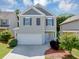 Charming two-story home features a two-car garage, neutral siding and dark shutters at 363 Lobdale Falls Dr, Lawrenceville, GA 30045