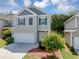 Charming two-story home features a two-car garage, neutral siding and dark shutters at 363 Lobdale Falls Dr, Lawrenceville, GA 30045