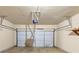 Spacious garage with overhead door, opener, and ample room for parking and storage at 363 Lobdale Falls Dr, Lawrenceville, GA 30045