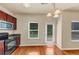 An eat-in kitchen with wooden cabinets, stainless steel appliances, and hardwood floors at 363 Lobdale Falls Dr, Lawrenceville, GA 30045