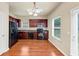 A kitchen featuring stainless steel appliances, wooden cabinets, and hardwood floors at 363 Lobdale Falls Dr, Lawrenceville, GA 30045