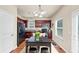 An eat-in kitchen with wooden cabinets, a black dining table, and hardwood floors at 363 Lobdale Falls Dr, Lawrenceville, GA 30045