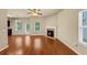 Bright living room featuring wood floors, a fireplace, ceiling fan and natural light at 363 Lobdale Falls Dr, Lawrenceville, GA 30045