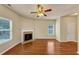 Bright living room featuring wood floors, a fireplace, ceiling fan and natural light at 363 Lobdale Falls Dr, Lawrenceville, GA 30045
