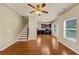 Open-plan living room featuring wood floors, staircase and kitchen area at 363 Lobdale Falls Dr, Lawrenceville, GA 30045