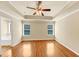Serene main bedroom with hardwood floors, tray ceiling, and bright windows that invite natural light at 363 Lobdale Falls Dr, Lawrenceville, GA 30045