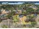 An aerial view shows the home nestled in a wooded lot near a large lake at 3745 Pilgrim Mill Rd, Cumming, GA 30041