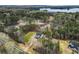 An aerial view shows the home nestled in a wooded lot with a view of the lake at 3745 Pilgrim Mill Rd, Cumming, GA 30041