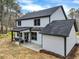 Back view of a house with a spacious backyard featuring green grass and a covered porch at 3745 Pilgrim Mill Rd, Cumming, GA 30041
