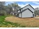 Side view of a house with a spacious backyard featuring green grass and a covered porch at 3745 Pilgrim Mill Rd, Cumming, GA 30041