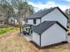 Back view of a house with a spacious backyard featuring green grass and a covered porch at 3745 Pilgrim Mill Rd, Cumming, GA 30041