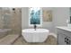 Elegant bathroom featuring a soaking tub, dual vanities, and a frameless glass shower at 3745 Pilgrim Mill Rd, Cumming, GA 30041