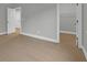 Bright bedroom with wood flooring and an open doorway leading to a spacious closet for convenient storage at 3745 Pilgrim Mill Rd, Cumming, GA 30041