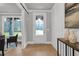 Bright entryway featuring hardwood floors, shiplap wall accents, and natural light from the door window at 3745 Pilgrim Mill Rd, Cumming, GA 30041