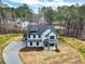 Two-story modern farmhouse with a lush lawn, stone trim, and a long concrete driveway at 3745 Pilgrim Mill Rd, Cumming, GA 30041