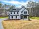 Charming two-story home with a modern farmhouse style and a well-manicured front yard at 3745 Pilgrim Mill Rd, Cumming, GA 30041