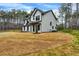 Charming two-story home with black trim and a covered porch, surrounded by a green lawn and trees at 3745 Pilgrim Mill Rd, Cumming, GA 30041