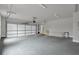 Garage interior with two car white door, concrete flooring and overhead lighting at 3745 Pilgrim Mill Rd, Cumming, GA 30041