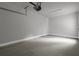 One car garage with a concrete floor, an overhead door, and white walls at 3745 Pilgrim Mill Rd, Cumming, GA 30041