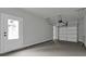 Garage interior with an automatic door opener, concrete flooring, and a door to outside at 3745 Pilgrim Mill Rd, Cumming, GA 30041